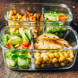 Healthy meal prep containers chicken and fresh vegetables